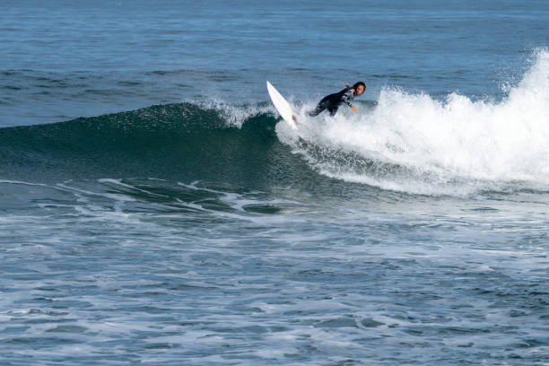 istock Surfer girl riding a wave 1425172558
