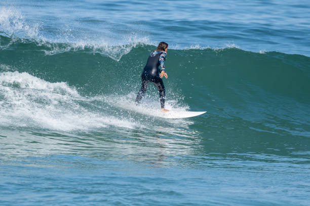 istock Surfer girl riding a wave 1425172759