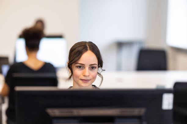 istock Young businesswoman working on computer at coworking office 1425175195