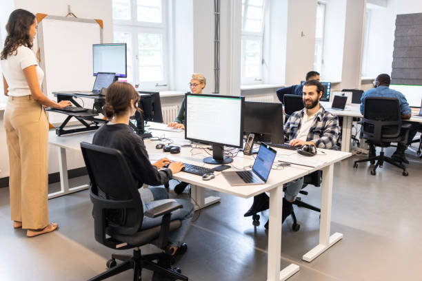 istock Multiracial business people working in an open plan office 1425175288
