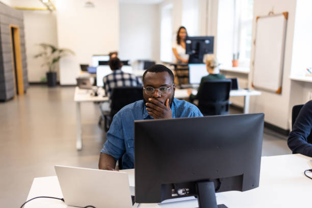 istock African businessman working on computer at coworking office 1425175300