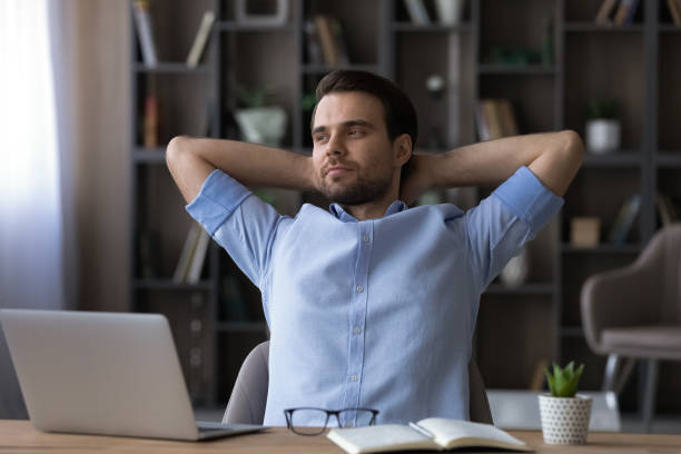 istock Happy young businessman relaxing in modern office room. 1425176034