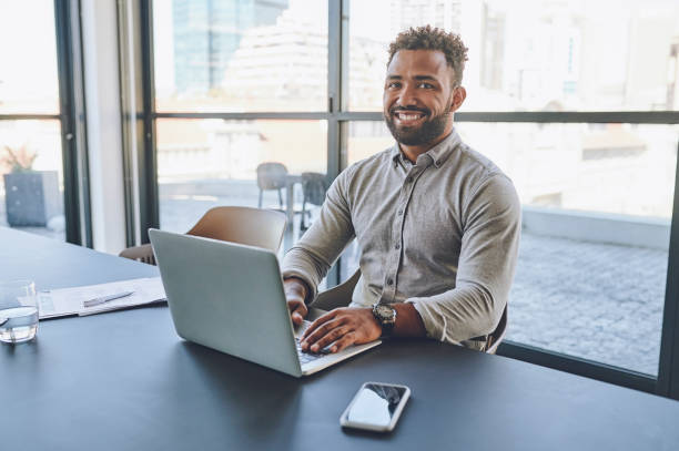 istock Laptop, working and businessman in office portrait while working on digital project, email or website update for company about us or our vision. Happy corporate man with online tech planning software 1425176161