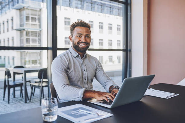 istock Businessman, laptop and digital marketing strategy with kpi data analysis paper, target audience research and brand innovation idea. Portrait of happy, smile and creative employee in office boardroom 1425176164