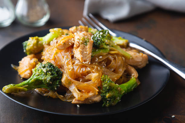 Stir fry, bean noodles with fried chicken fillet and broccoli Stir fry, bean noodles with fried chicken fillet and broccoli asian food stock pictures, royalty-free photos & images