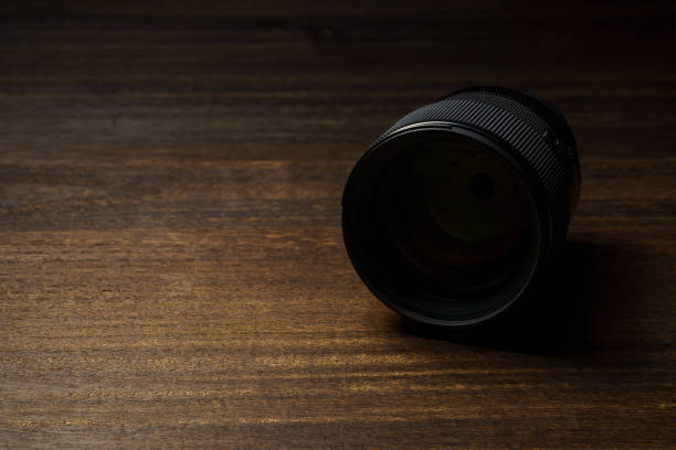 Close up of camera lens on wooden table