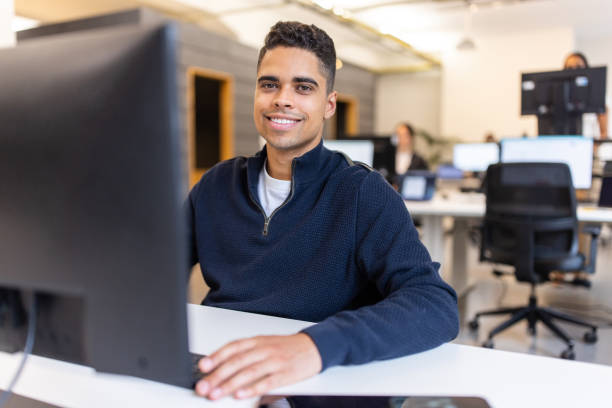 istock Portrait of a happy Hispamic businessman working on desktop computer at a startup 1425179194