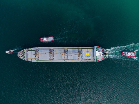 Aerial view cargo ship in port at container terminal port, freight ship standing in terminal port on loading, unloading container, Commercial cargo ship in sea port.