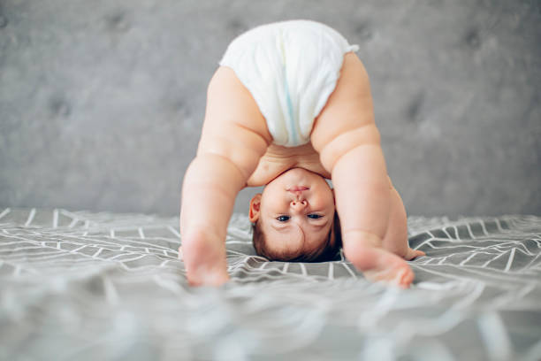 Attempting my first steps Baby standing upside down on a bed, attempting to stand or crawl pics of girls buttocks stock pictures, royalty-free photos & images
