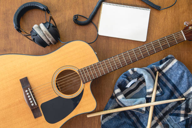 istock Music background with guitar, headphones and notepad, top view. 1425180674