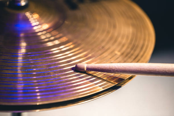 Close-up of drumsticks on a cymbal drum.