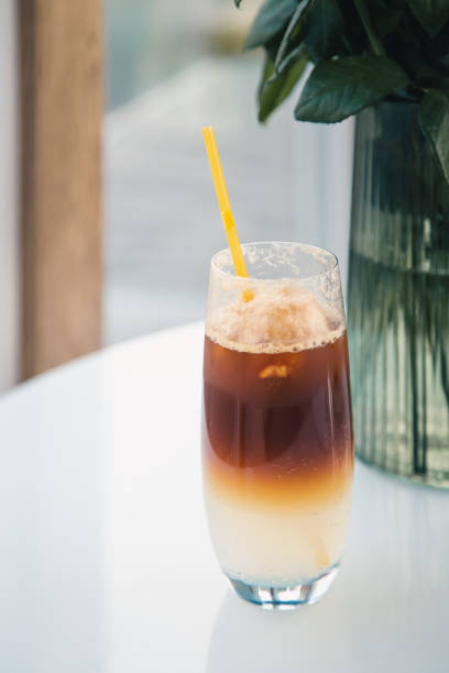 istock Espresso tonic in a glass with a yellow drinking straw. 1425184798