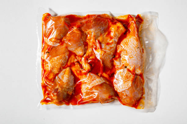 istock Raw marinated chicken legs in vacuum packaging on a white background 1425186965