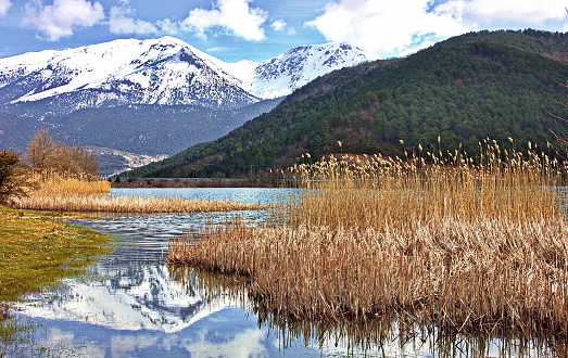 Snow-capped mountain reflected in calm lake water, Corinthia, Peloponnese, Greece, .