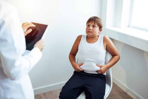 obese child listening to nutritionist's recommendations. - child obesity imagens e fotografias de stock