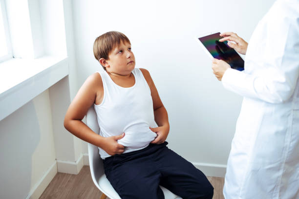 istock Overweight boy consulting with doctor in office 1425191267
