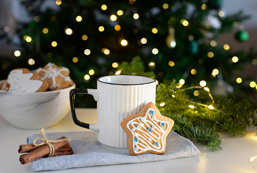 gingerbread cookies and milk for Santa on blurred lights background. Christmas composition.