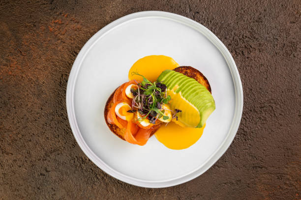 istock Delicious healthy breakfast, snack - sandwich with avocado, plates  on white table background. 1425195171