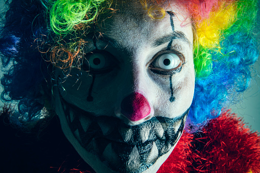 A close up of a creepy clown.