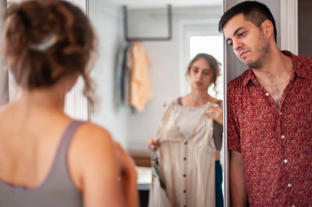 istock Cheerful Young couple trying on clothes and having fun 1425200641