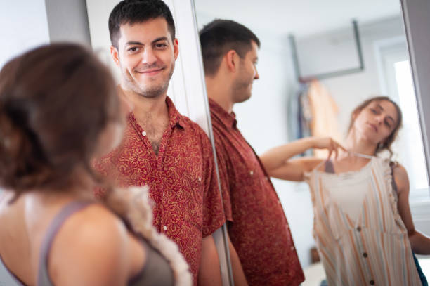 istock Cheerful Young couple trying on clothes and having fun 1425200908
