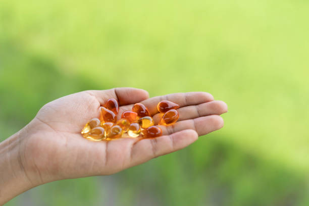 istock Vitamins in a hand on natural light background. 1425203562