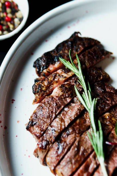 istock Sliced grilled steak medium rare served on white plate with vegetables 1425203689