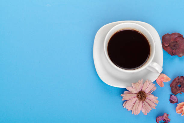 istock Cup of coffee on a blue table 1425203788