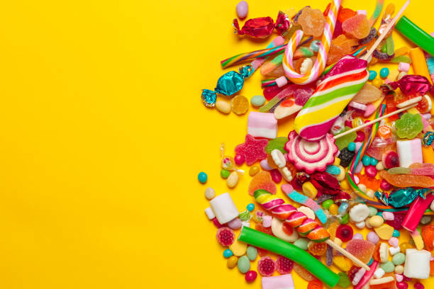 istock colored candies on yellow background 1425203801