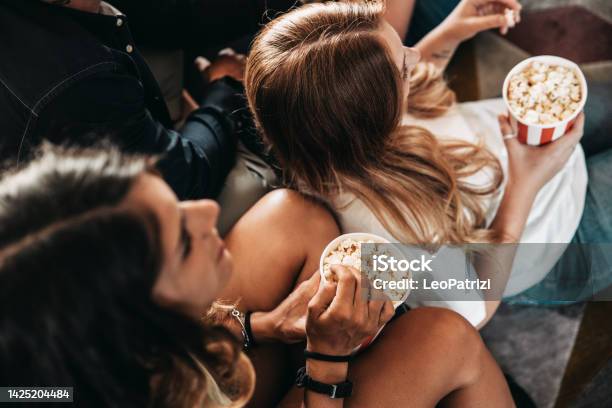 Friends Watching A Movie At The Movie Theater Stock Photo - Download Image Now - Movie Theater, Popcorn, Television Industry