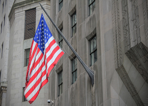 United States or America Flags  on the facade of a building in midtown New York City.