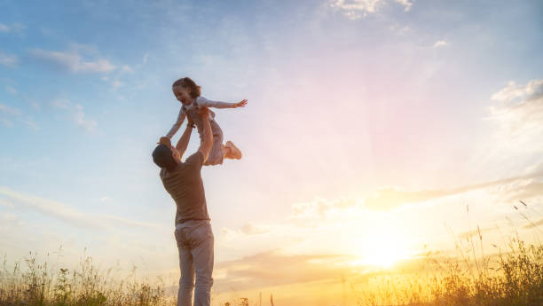 istock Happy family at sunset 1425210959