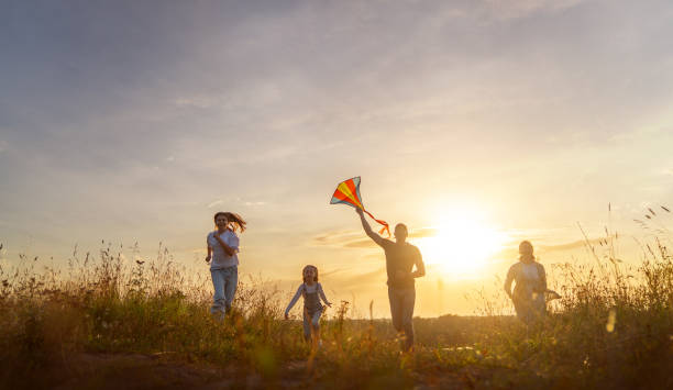 istock Happy family at sunset 1425210967