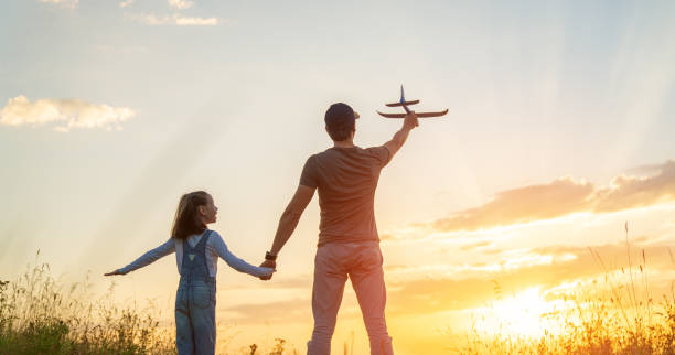 istock Happy family at sunset 1425210971