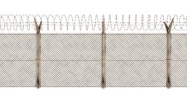 fence with barbed wire coil on top - razor wire imagens e fotografias de stock