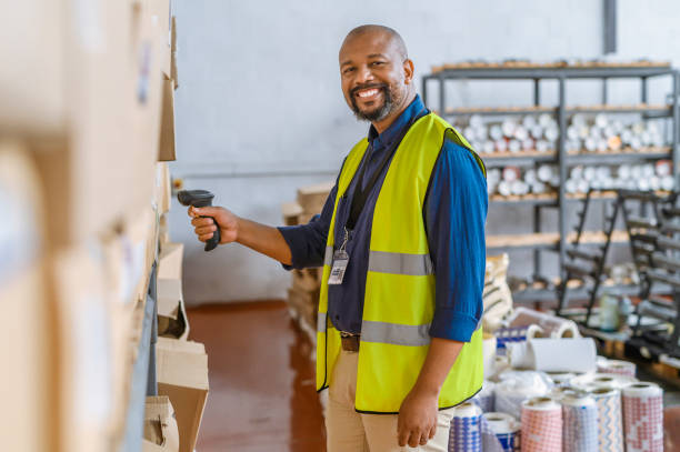 istock Happy black man, logistics and warehouse scanner for checking package, stock for delivery or inspection. Portrait of a African male employee smile scanning boxes, packaging or cargo for supply chain 1425217937