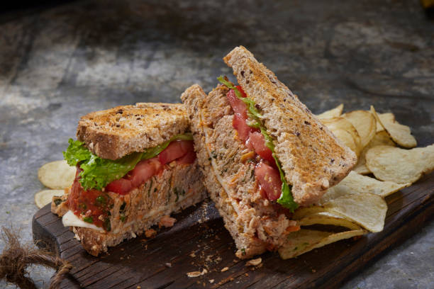 Leftover Turkey Meatloaf Sandwich with Lettuce, Tomato and Havarti Cheese on Whole Grain Toast and Potato Chips