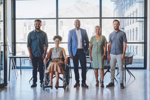 istock Diversity, disability inclusive and business team of workers happy with teamwork at work. Portrait of corporate workforce with a smile ready for a collaboration project feeling community support 1425223931