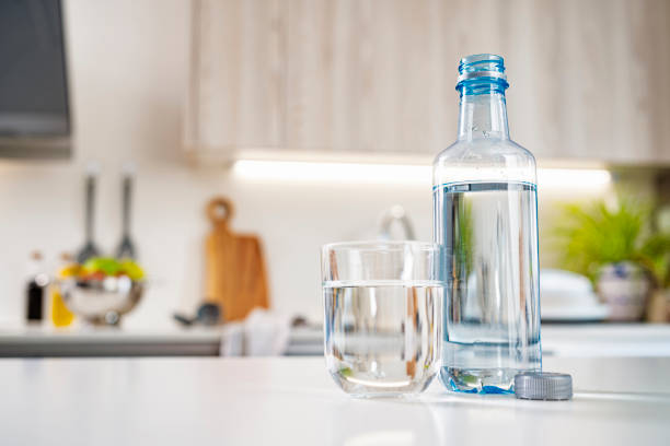 istock Water bottle and drinking glass on kitchen counter 1425227397