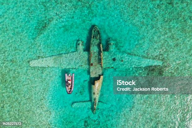 Plane Crash With Small Boat Over Top Stock Photo - Download Image Now - Bahamas, Exuma, Drone