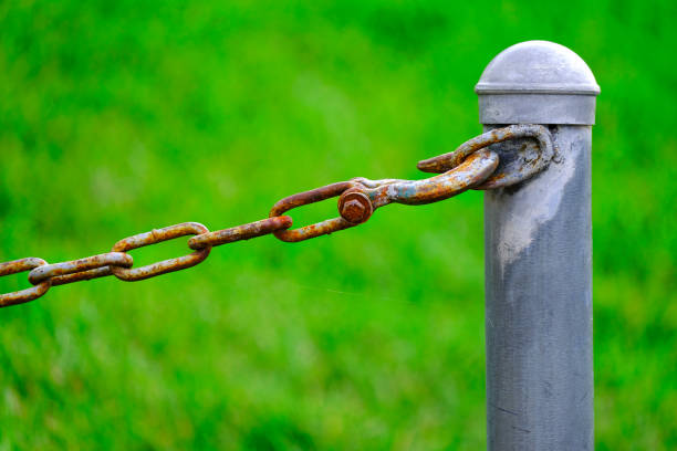 istock Chain Connected to Pole for Security and Protection Green Background 1425227860