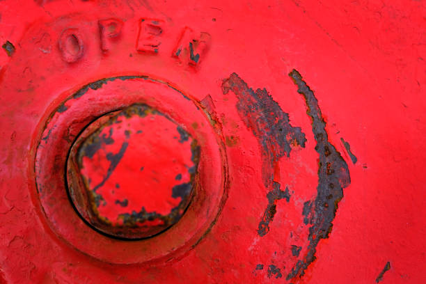 Top of red fire hydrant with word open by bolt for valve