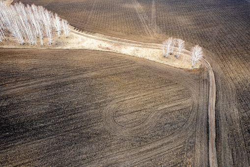 Vista de drones de un campo rural con tierra arada, rastros de maquinaria en el suelo photo