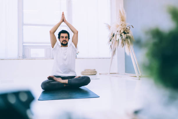 istock Man doing seated Lotus position with hands up 1425233556