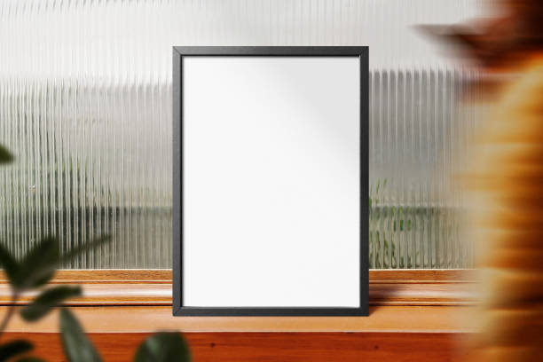 istock Clean minimal frame mockup standing on wooden top with leaves 1425240493