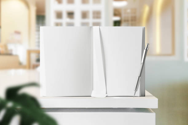 istock Clean minimal Inner book 4x6 mockup standing on white table with leaves 1425240495