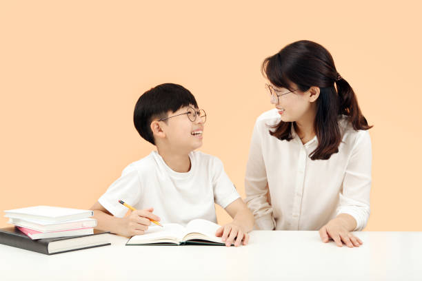 Happy study time A child learning with a teacher or mother smiling brightly Happy learning time Children who study with a teacher or mother smiling brightly and having fun teachers stock pictures, royalty-free photos & images