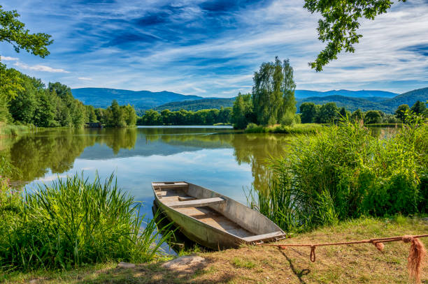 View on peaceful lake in the Karkonosze mountains and boat.