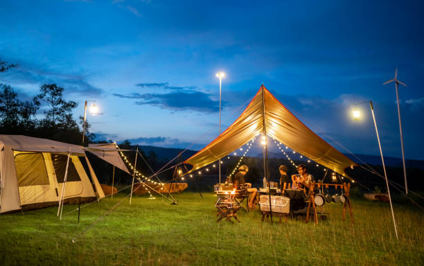 istock Night camping atmosphere. It is a low-light night shot with noise and grain. Long exposure photography causes moving parts to blur. There will be sharpness only at the selected focus point. 1425242863