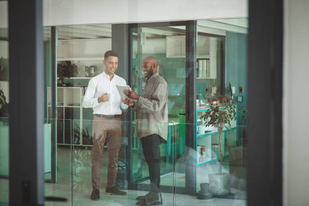 istock Two happy business men looking at their digital tablet 1425242982